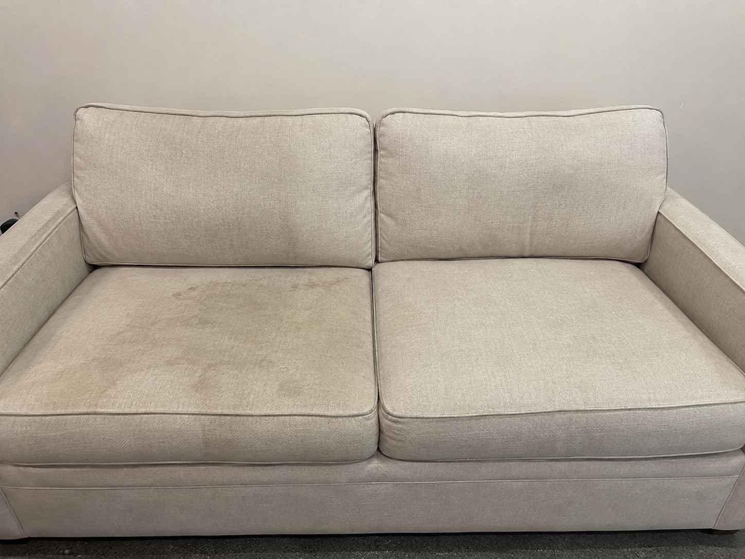 Before professional upholstery cleaning - stained and soiled sofa fabric