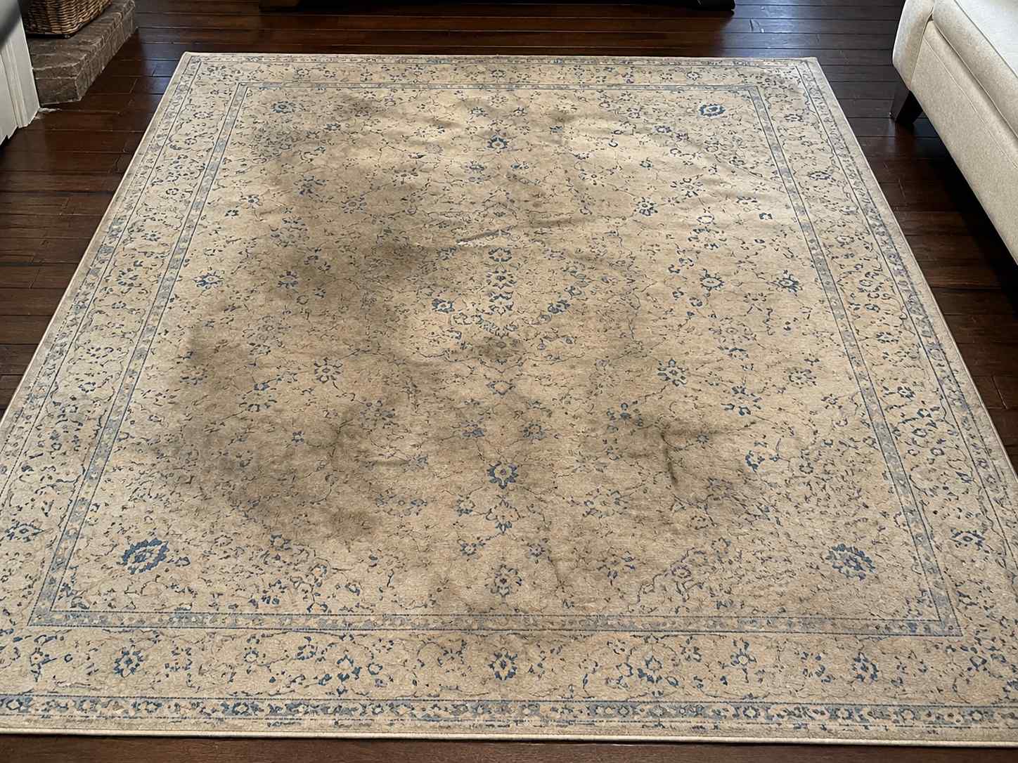 Before professional rug cleaning - dull, dirty area rug with traffic lanes